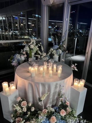 Candlelit sweetheart table with skyline view and pastel florals
