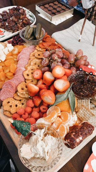 Abundant charcuterie board with fruits, cheeses, and cured meats