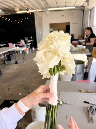 White rose bridal bouquet inside a florist workshop