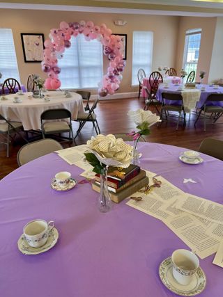 Lavender tea-party tablescape with vintage cups and balloon arch