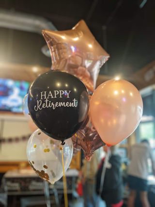 Rose-gold and black retirement balloon bouquet