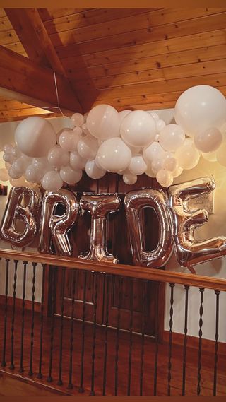 Bridal suite balloon arch with rose-gold BRIDE letters