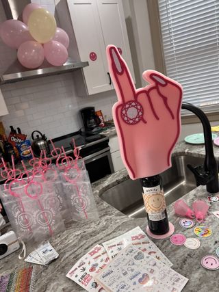Bachelorette kitchen setup with foam finger and themed cups